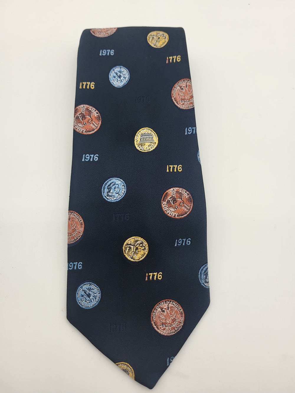 Oleg Cassini Navy Tie with Gold, Copper and Light Blue Coin Motif